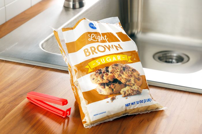 bag of brown sugar next to a sink on a kitchen counter