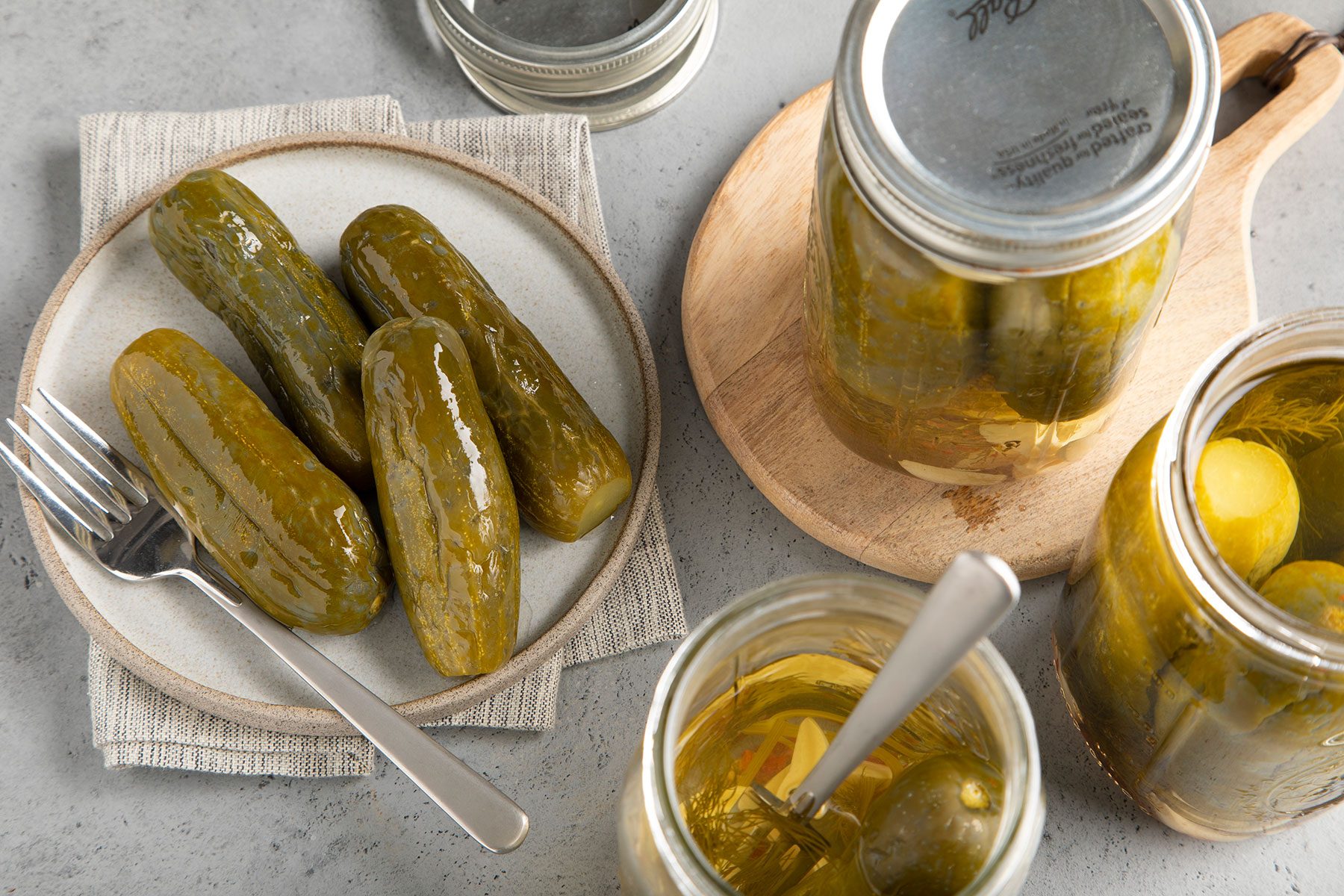 Old Fashioned Garlic Dill Pickles served on plates with fork
