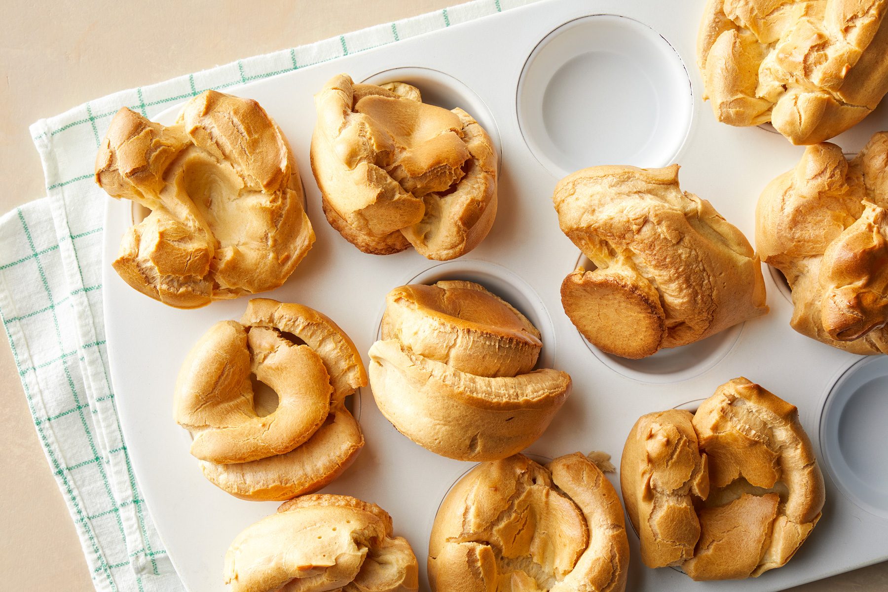 A muffin tray with baked Popovers