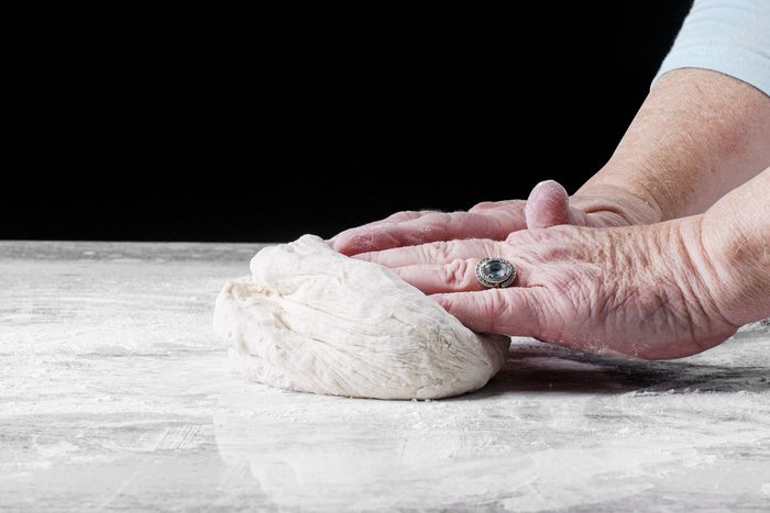 Knead the with hands dough on a floured surface