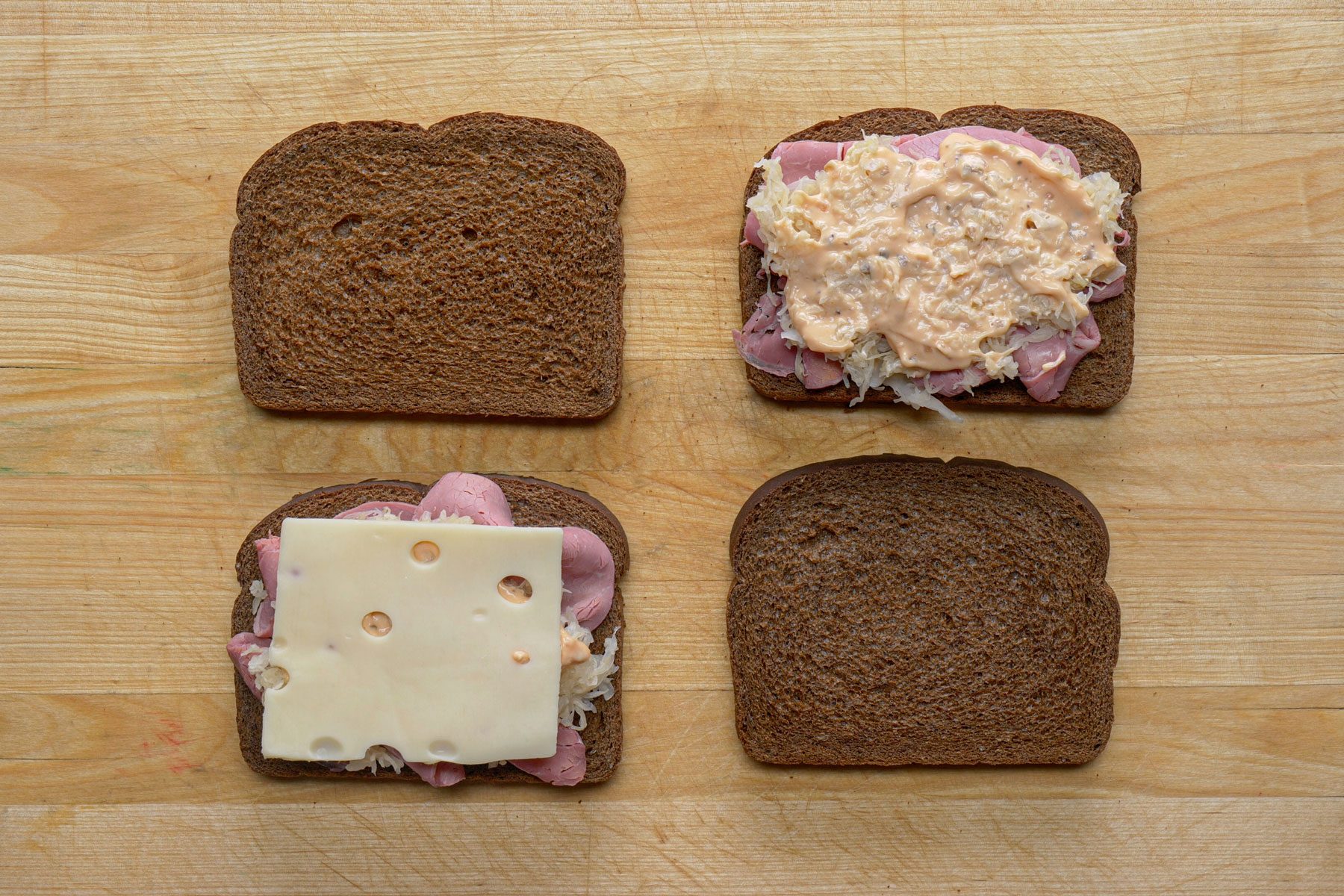 Slice of cheese sauce beef and sauerkraut layered on bread