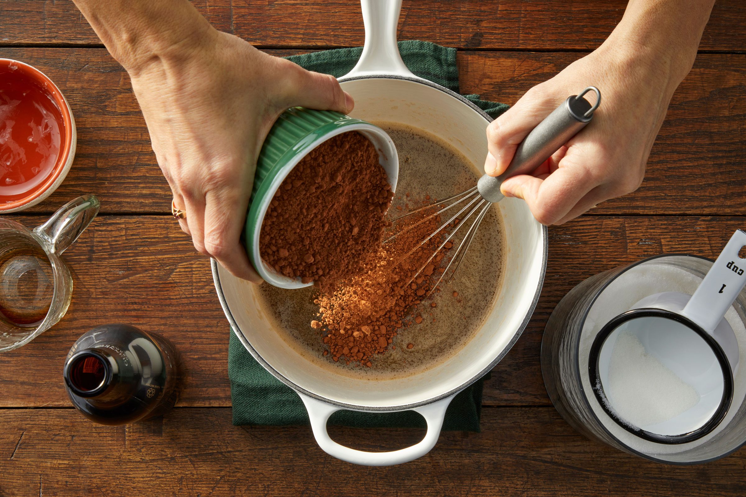 whisking beer and cocoa in small pot on hot plate