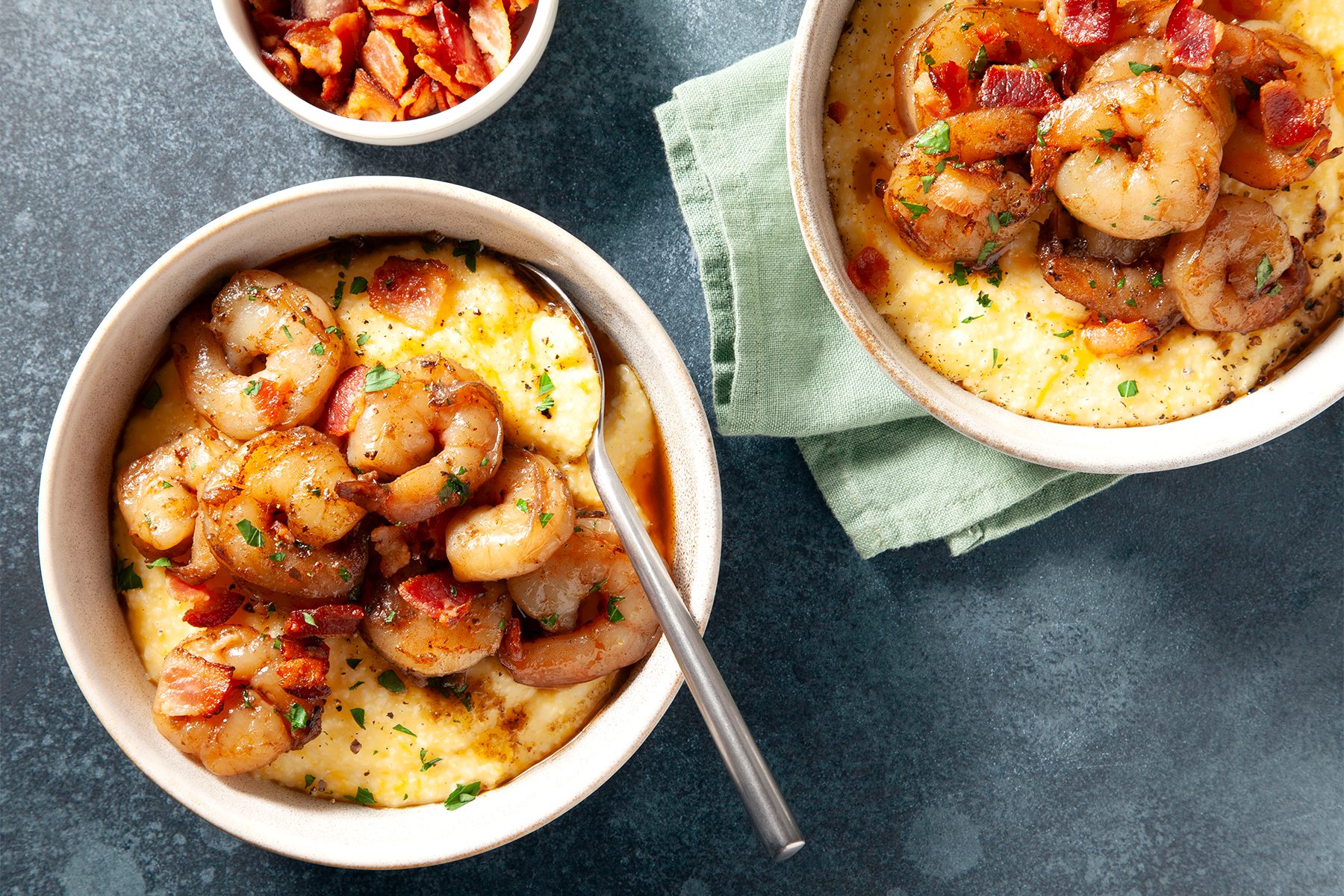 Two bowls of cheesy cajun shrimp and grits