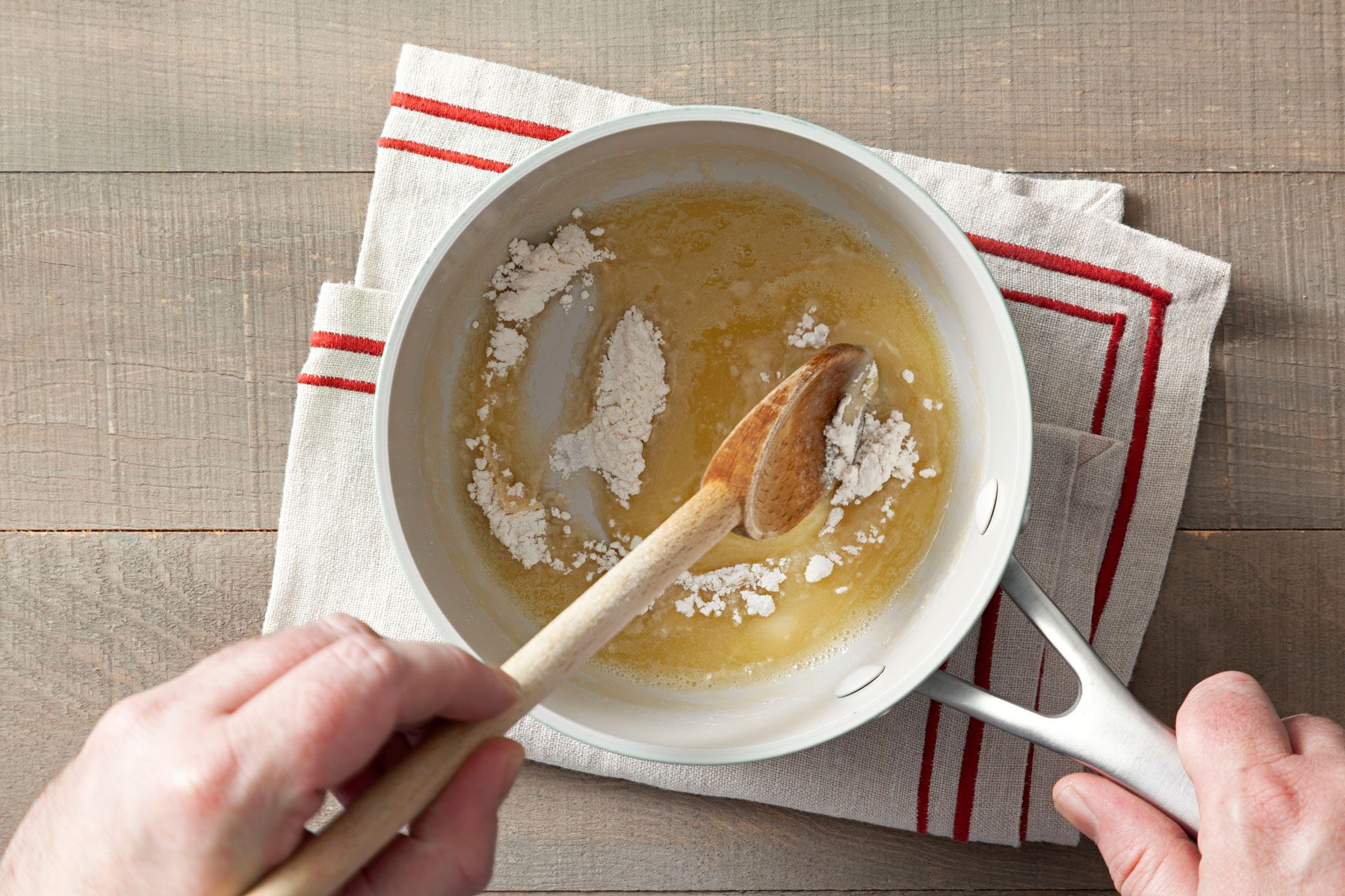 Mixing flour and butter in a large pan with a spatula