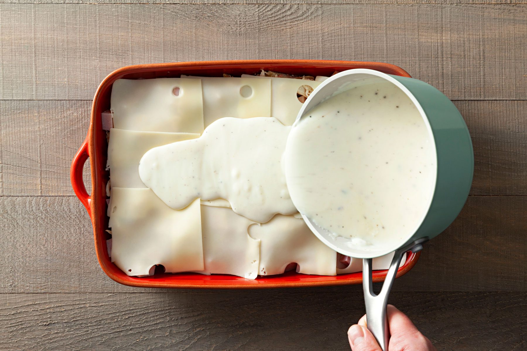 Pour the sauce evenly over the cheese layer