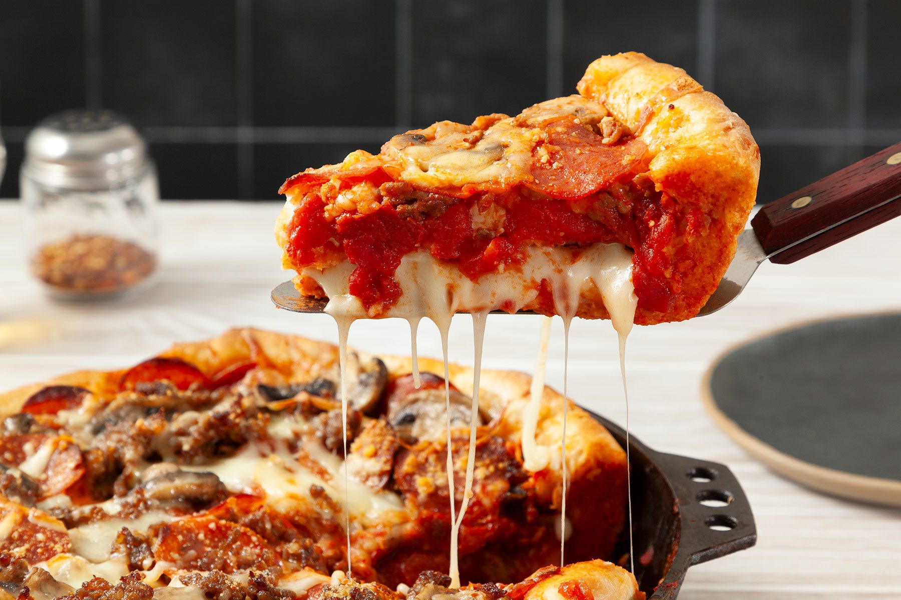 Picking up a slice of Deep Dish Pizza Slice