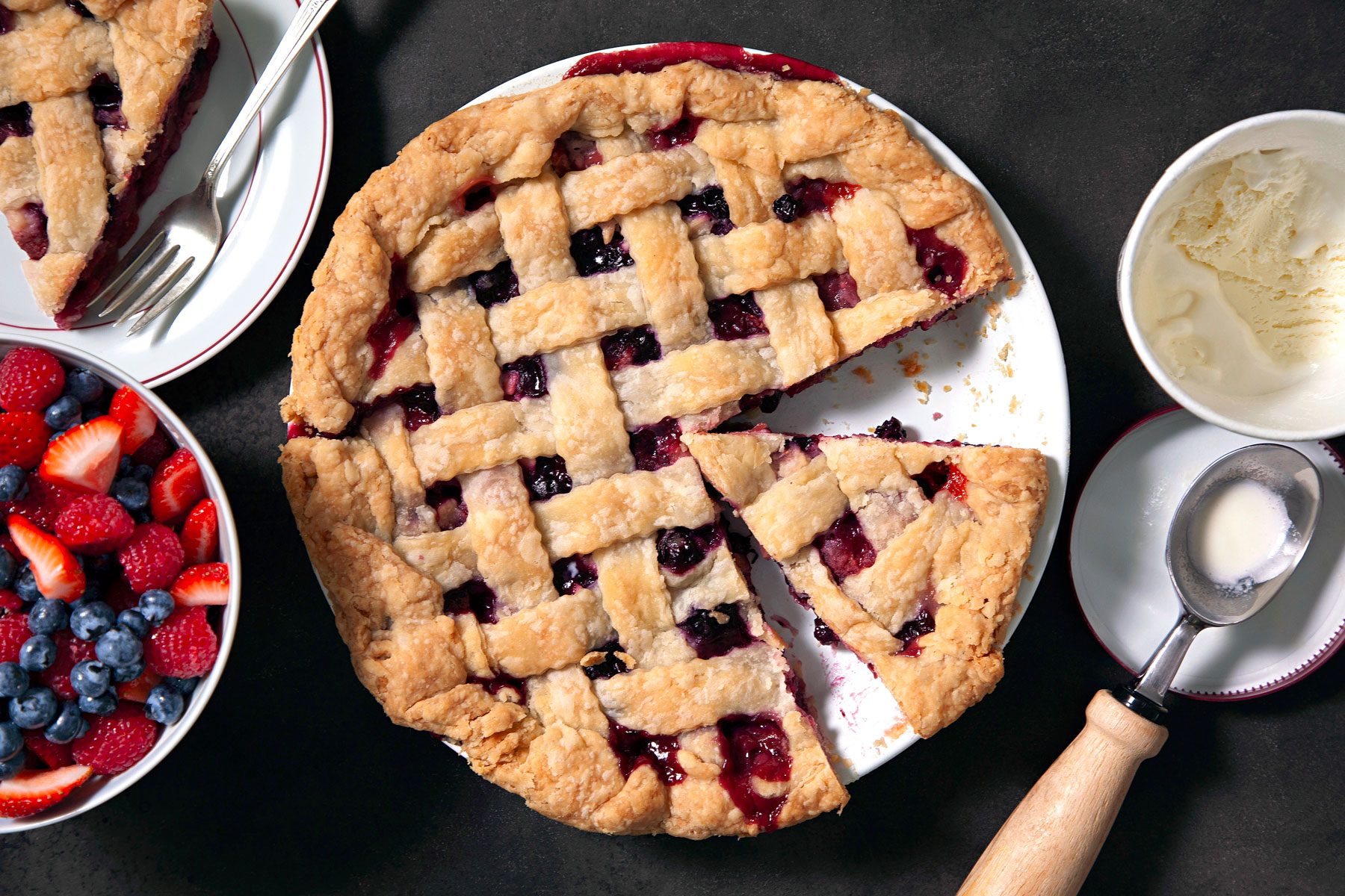 Flaky Bumbleberry Pie served in a plate on a surface.