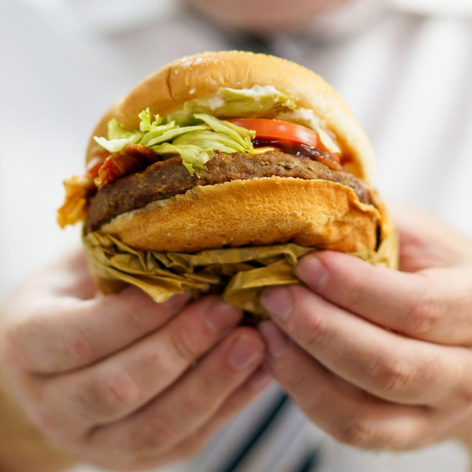 A man eating cheeseburger.