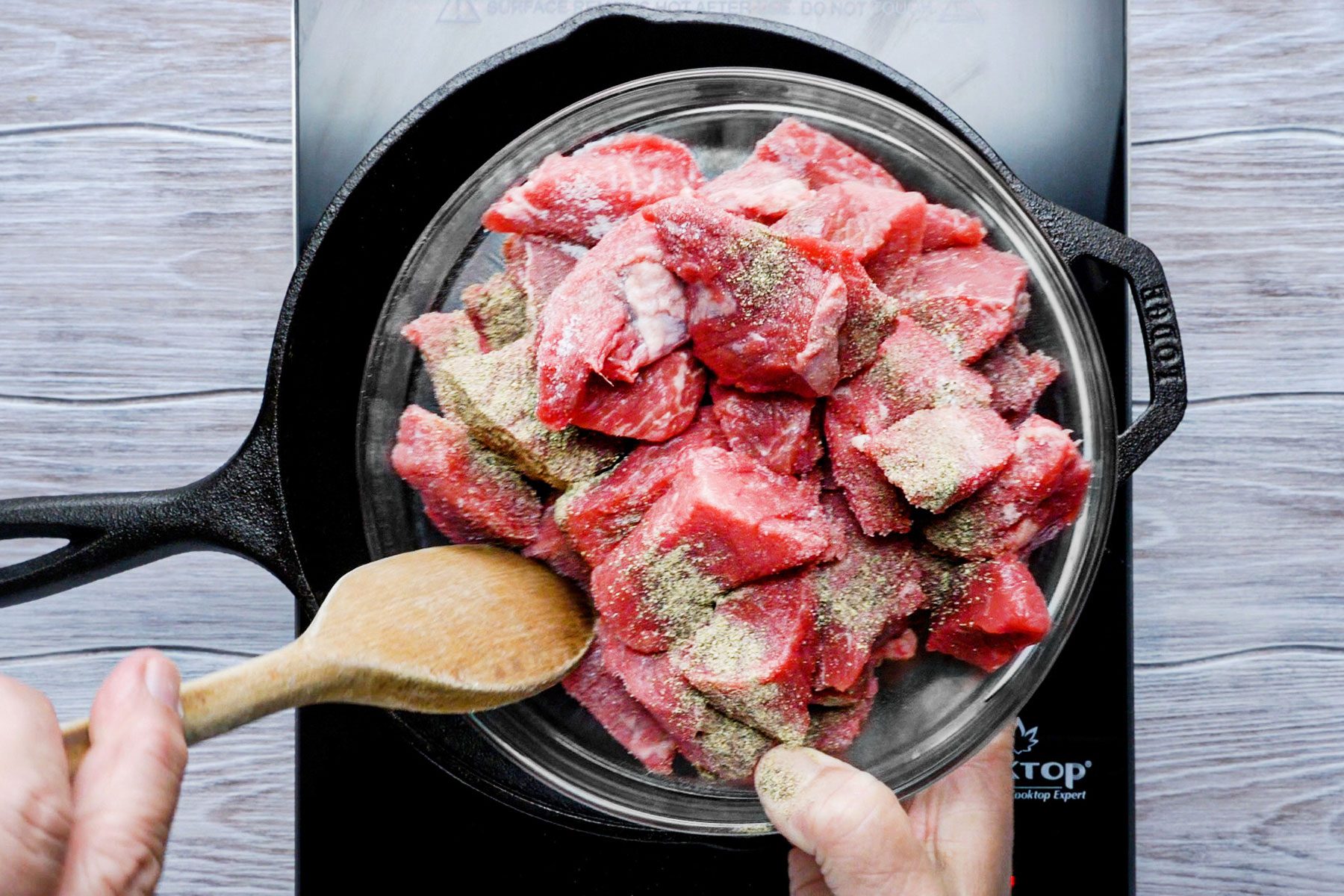 Putting meat in a large skilled sprinkled with salt and pepper