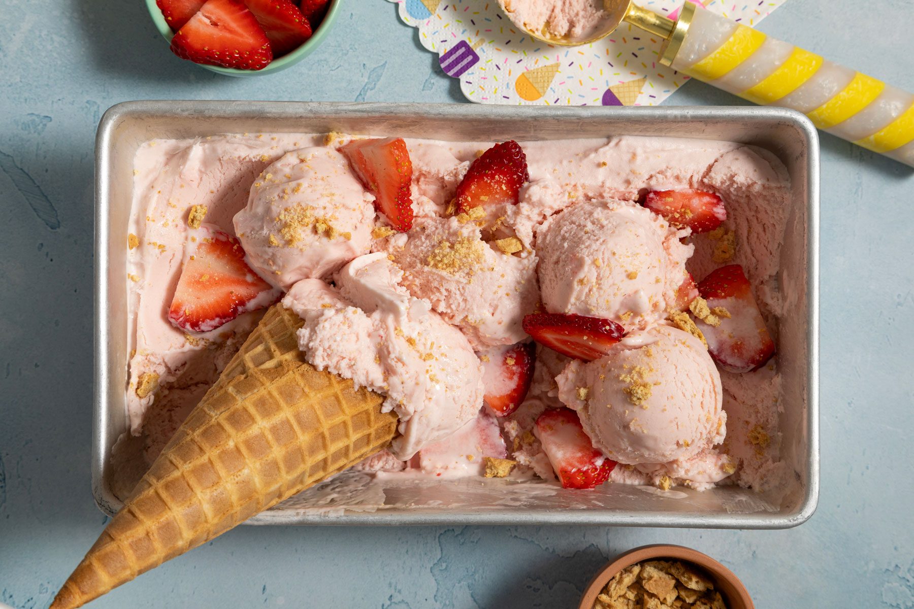 Strawberry Cheesecake Ice Cream with cone and strawberries 