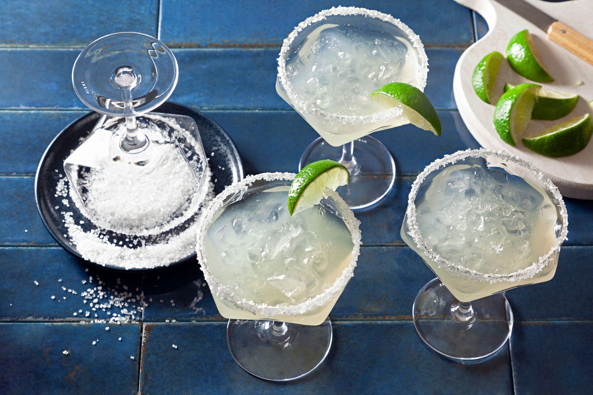 Three Virgin Margaritas with lemon slices on the side