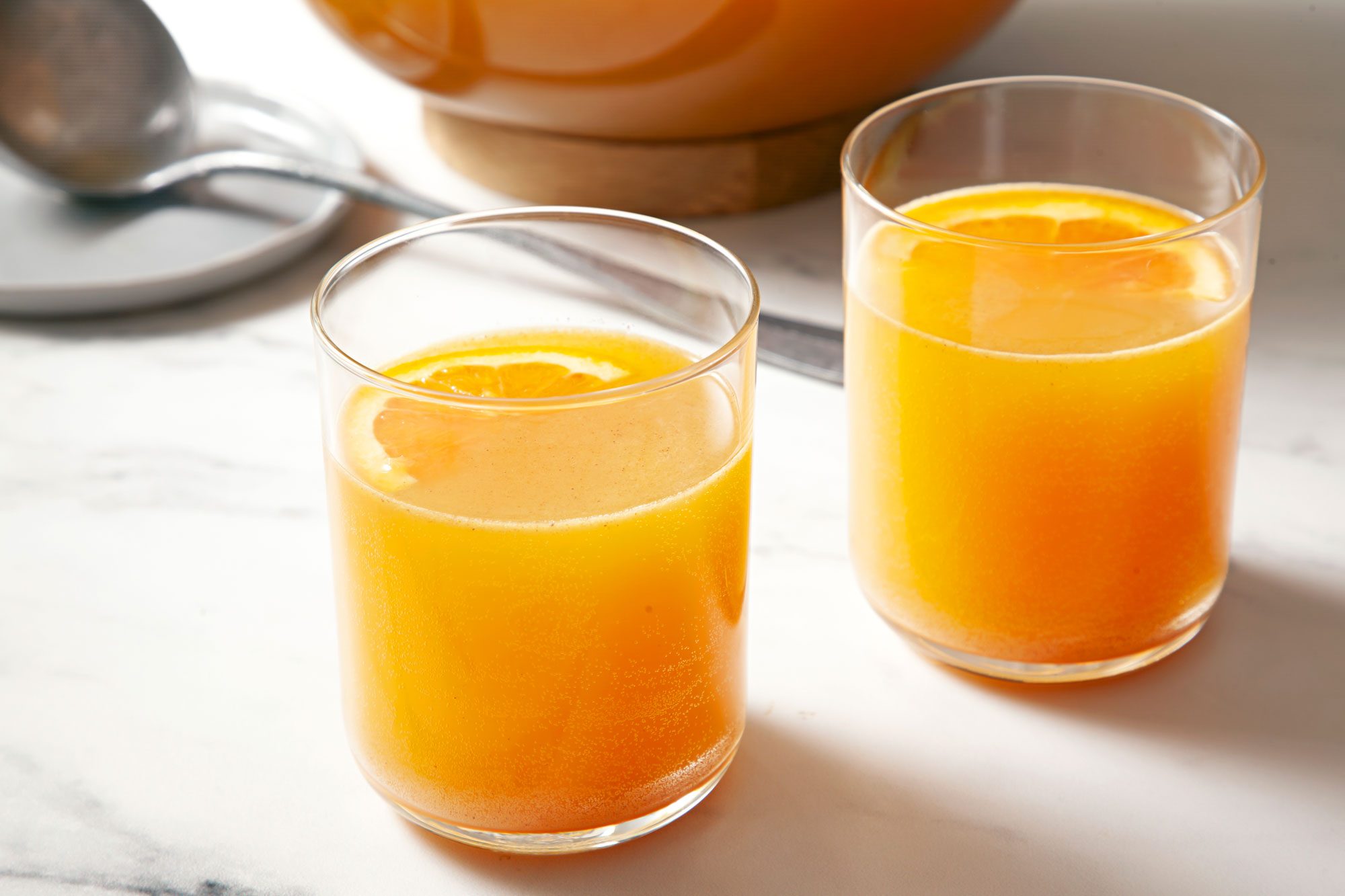 Apple Cider Punch served in two glasses garnished with orange slices