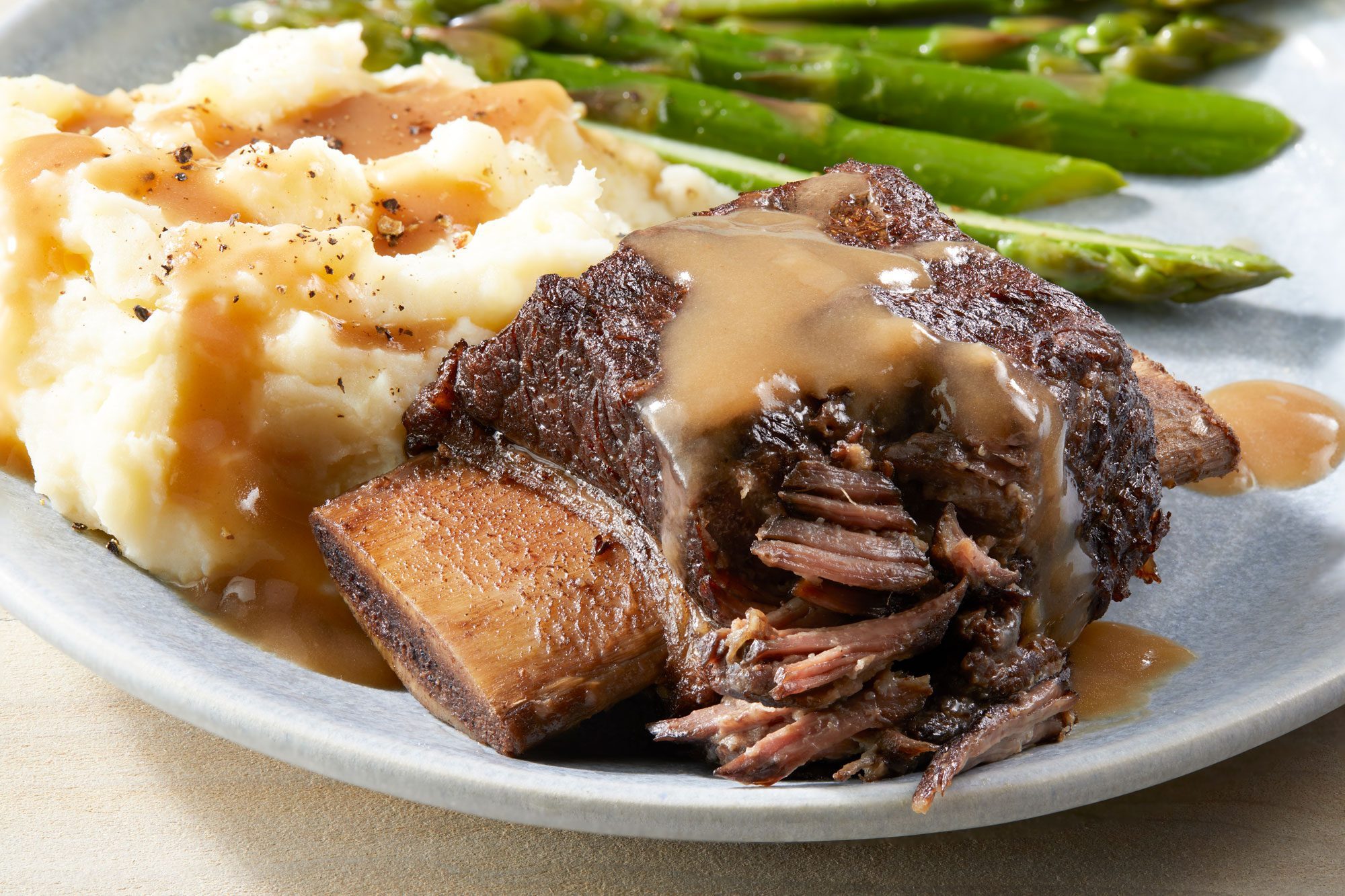 Braised Short Ribs served in a plate with celery