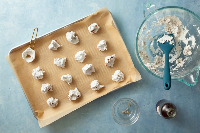 Dropped candy mixture on pan with spoon