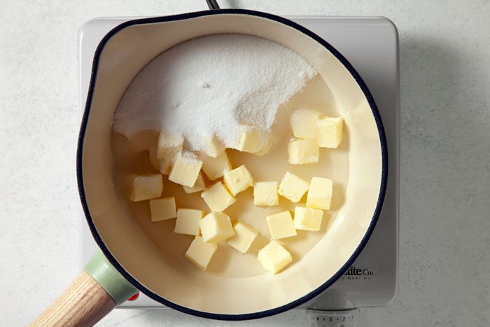 overhead shot of sugar, butter and water in a small saucepan