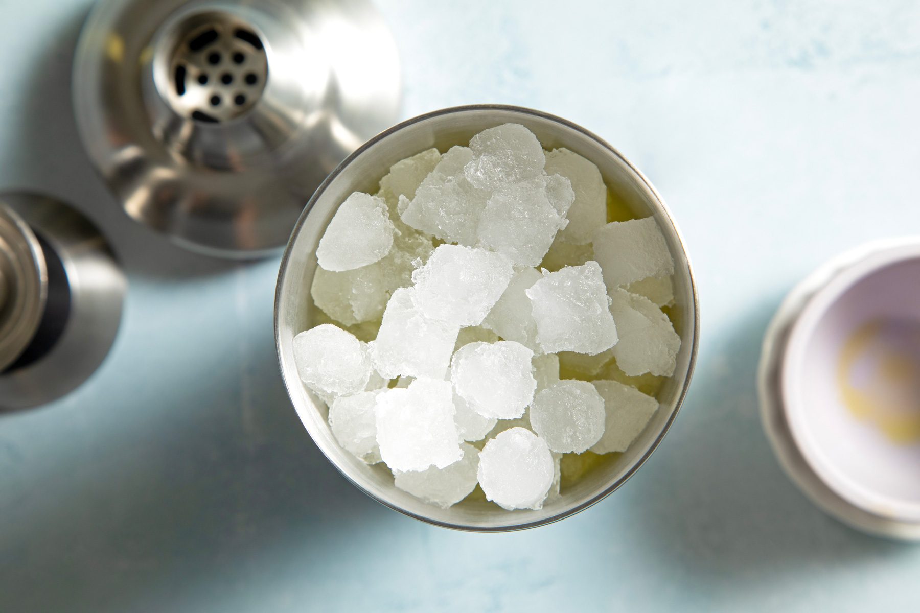 A cocktail shaker filled with ice cubes