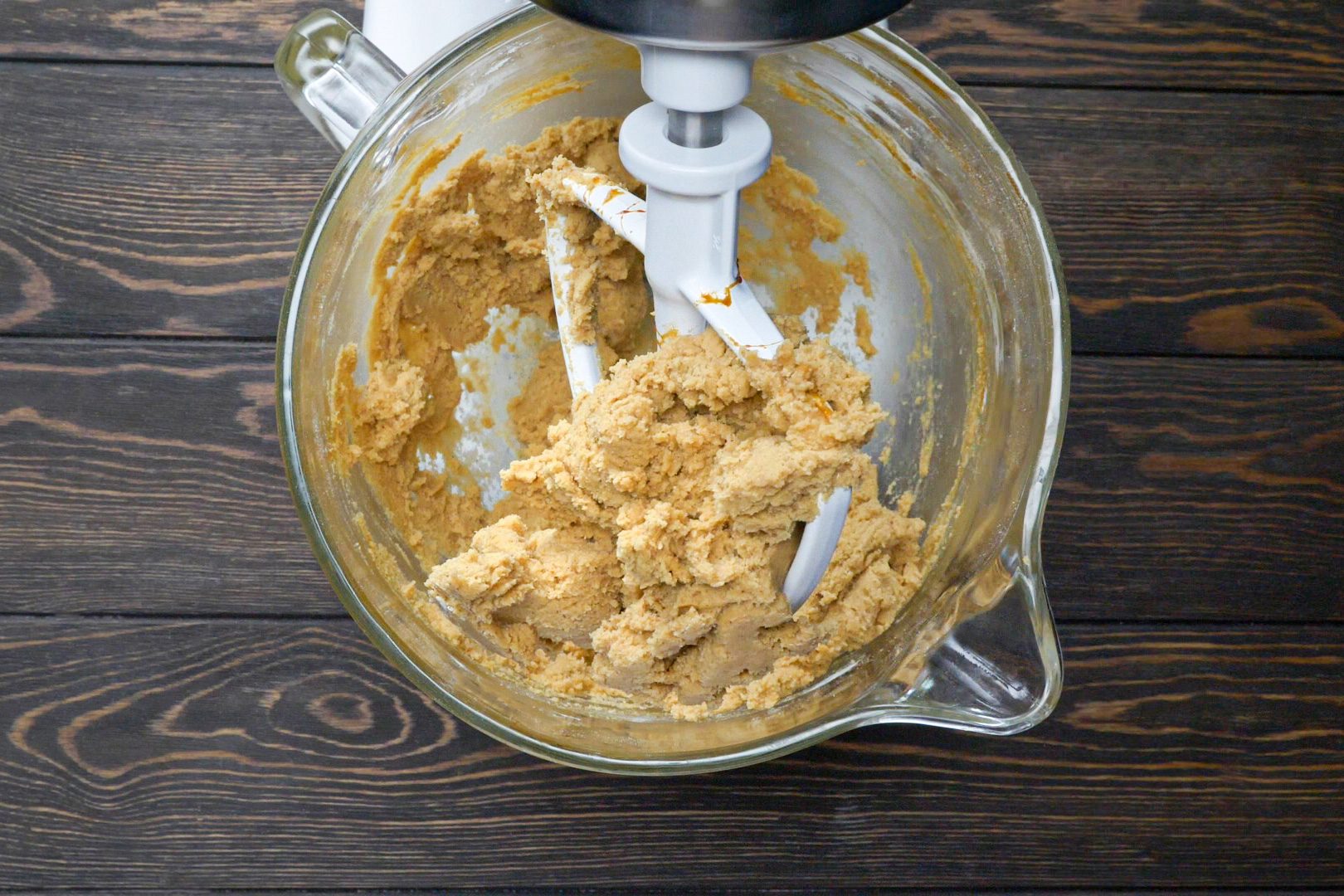 A mixing jar of flour and other ingredients on a wooden table