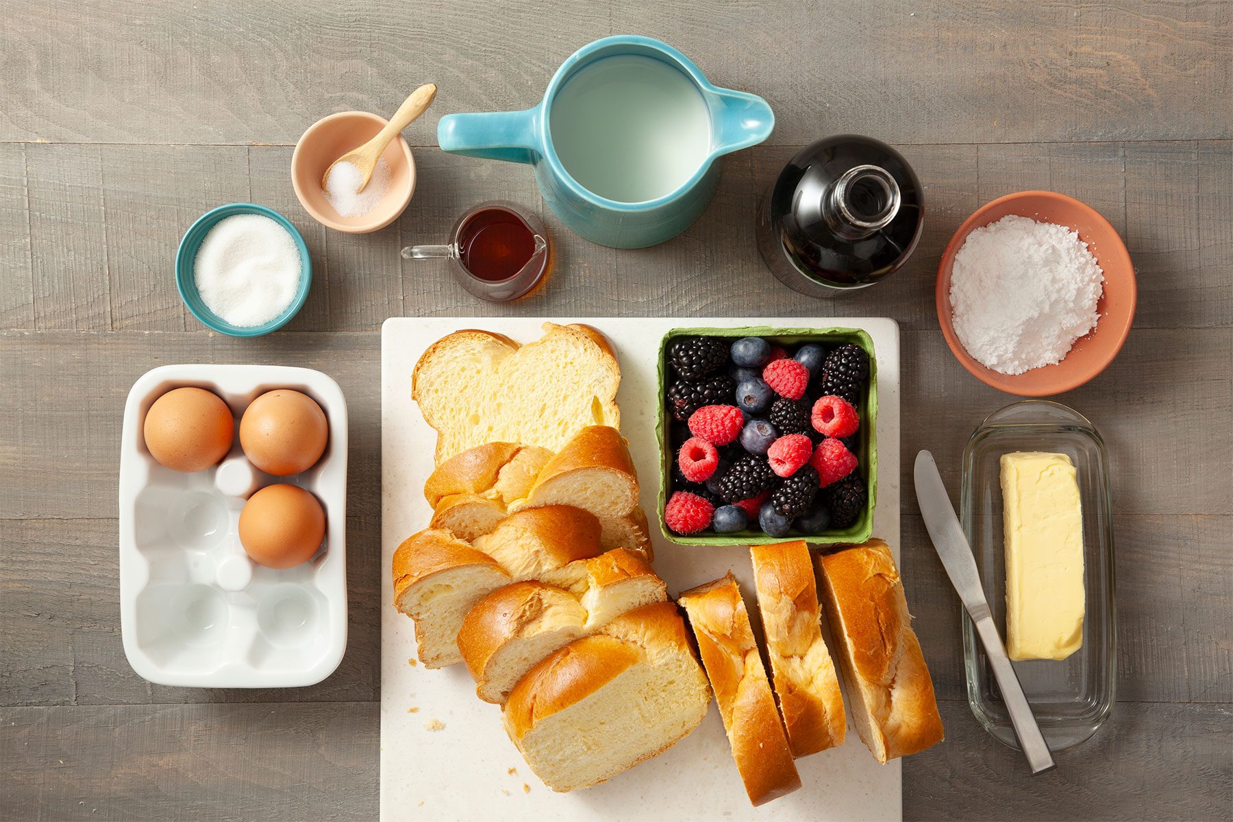 Overhead shot of all ingredients; chopping board; knife; light wooden background;