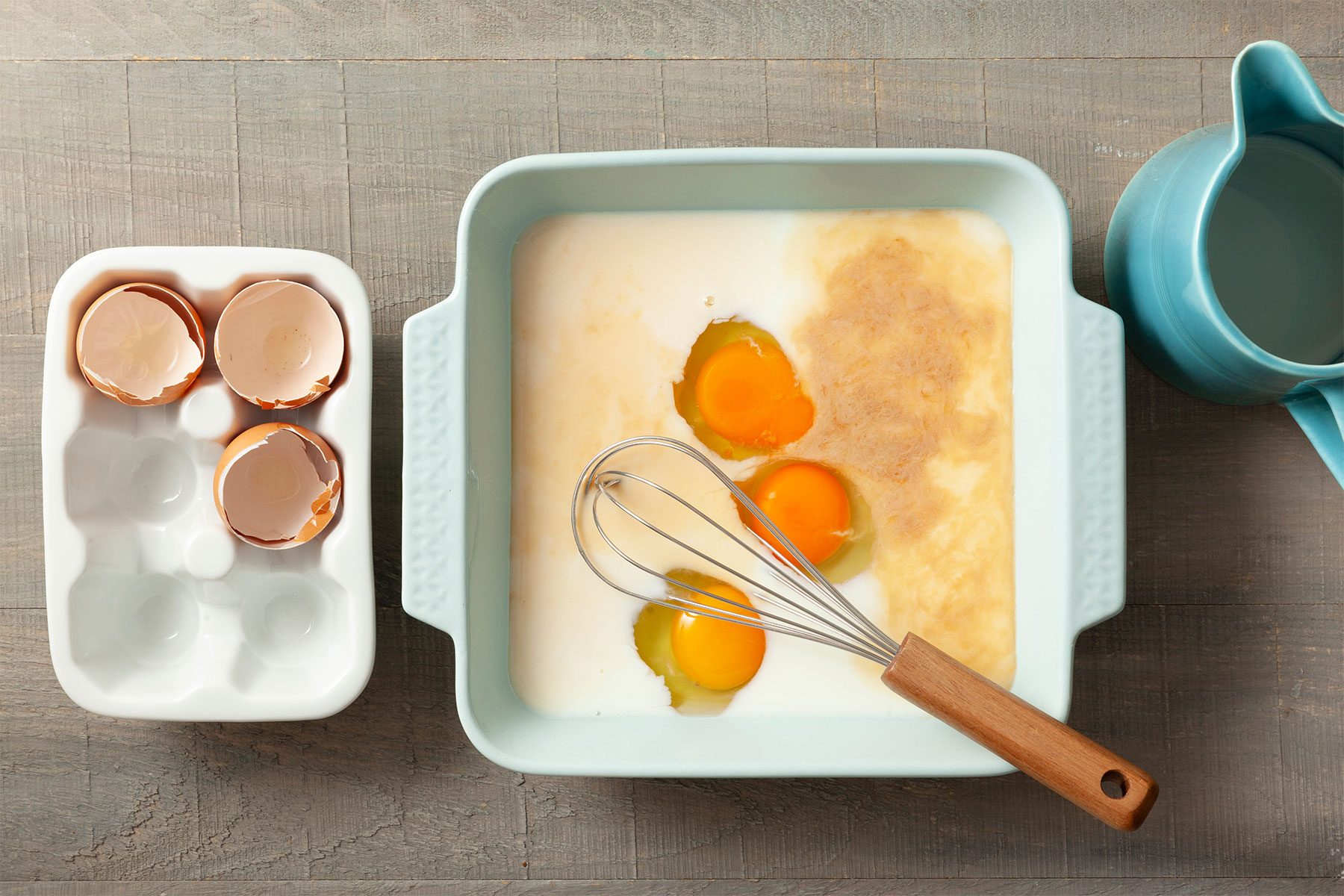 Overhead shot of a shallow dish; whisk together the first 5 ingredients; light wooden background;