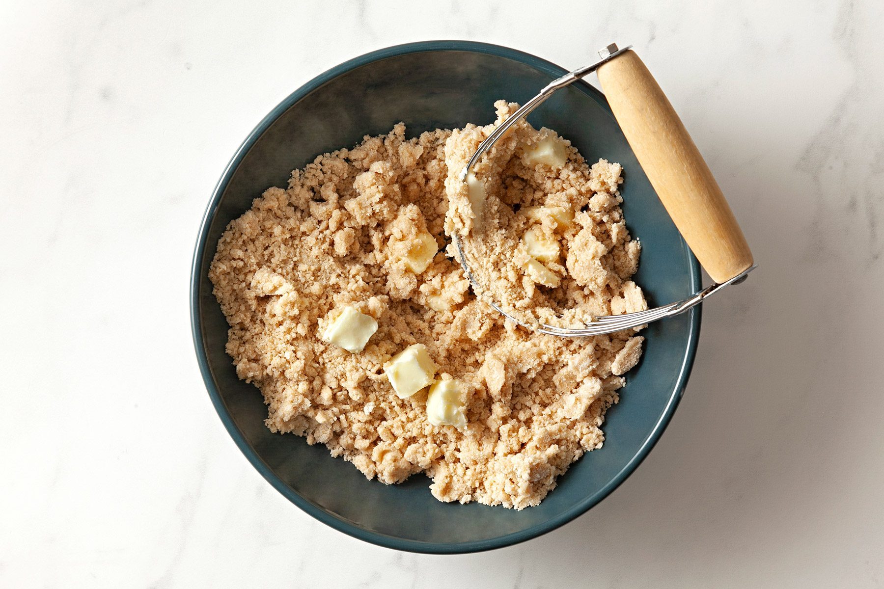 overhead shot; white background; In a bowl, combine salt, sugar and flour and cut in butter