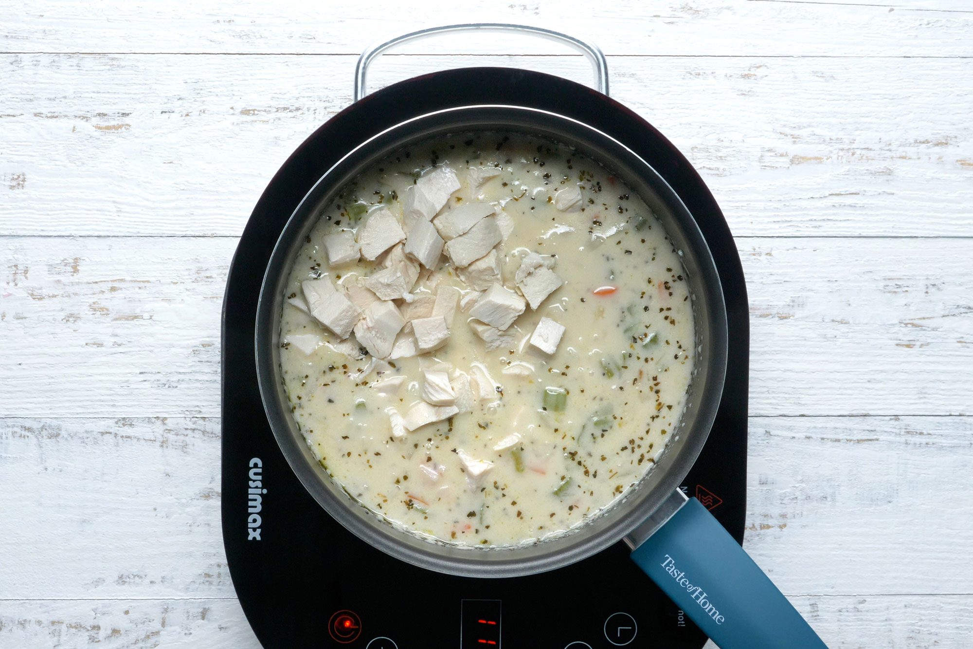 Stir the cooked chicken and warm until heated through in the pot
