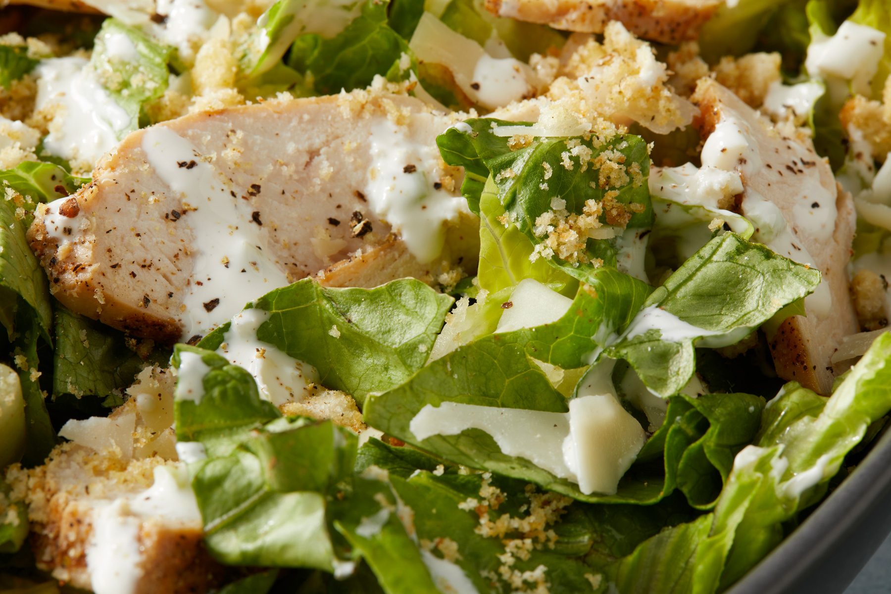 A bowl of Creamy Garlic Salad Dressing on a table.