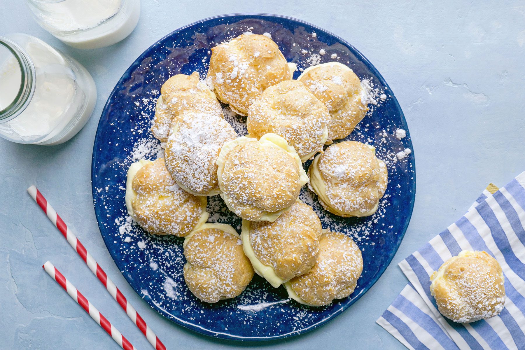 overhead shot of mini cream puffs served with milk