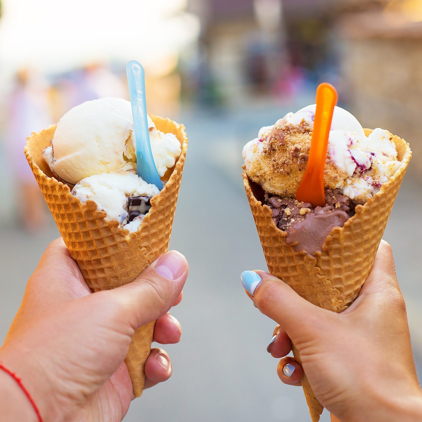 Beautiful bright ice cream with different flavors in the hands of a couple