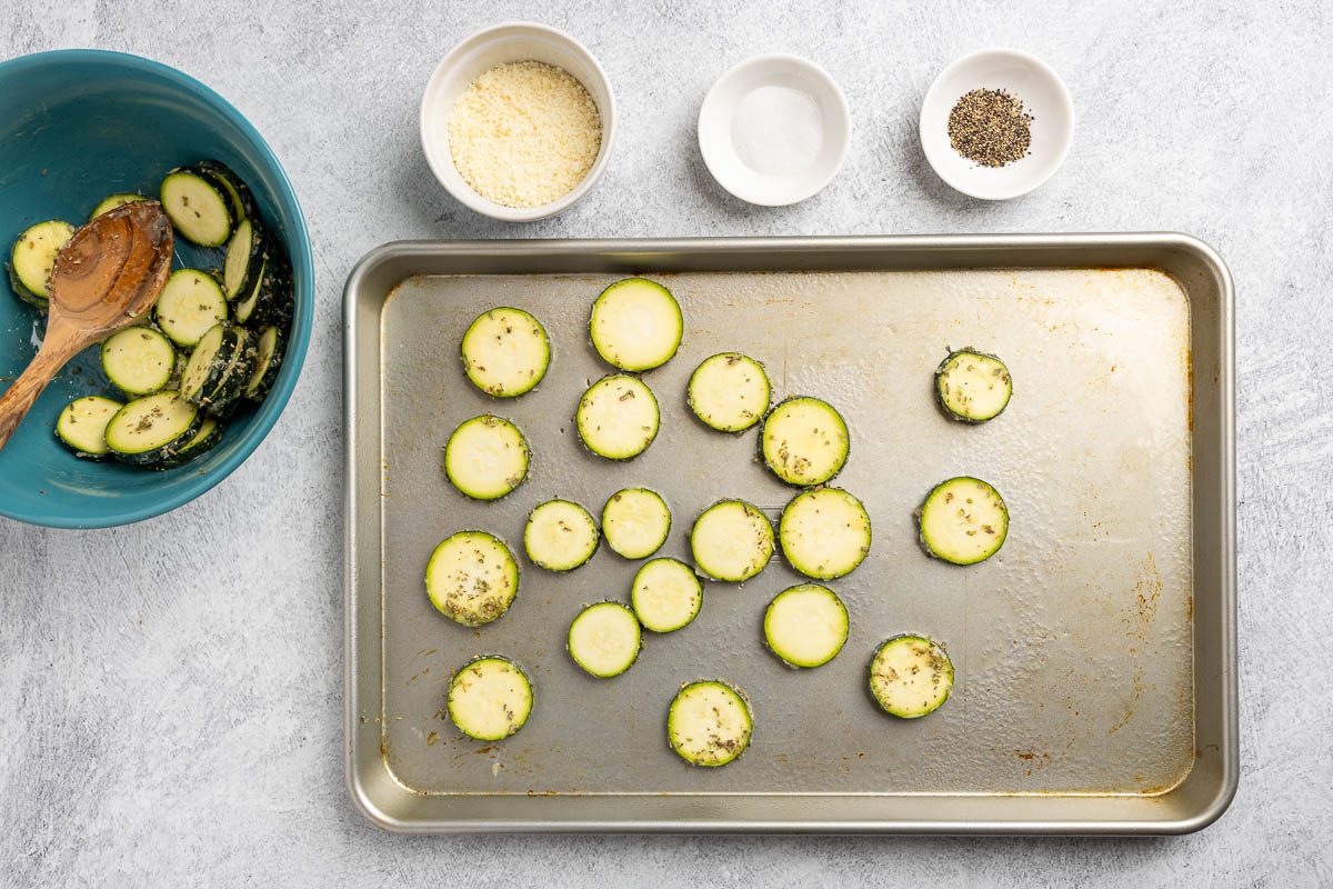 Taste of Home roasted zucchini recipe photo of raw zucchini placed on a sheet pan and seasoned.