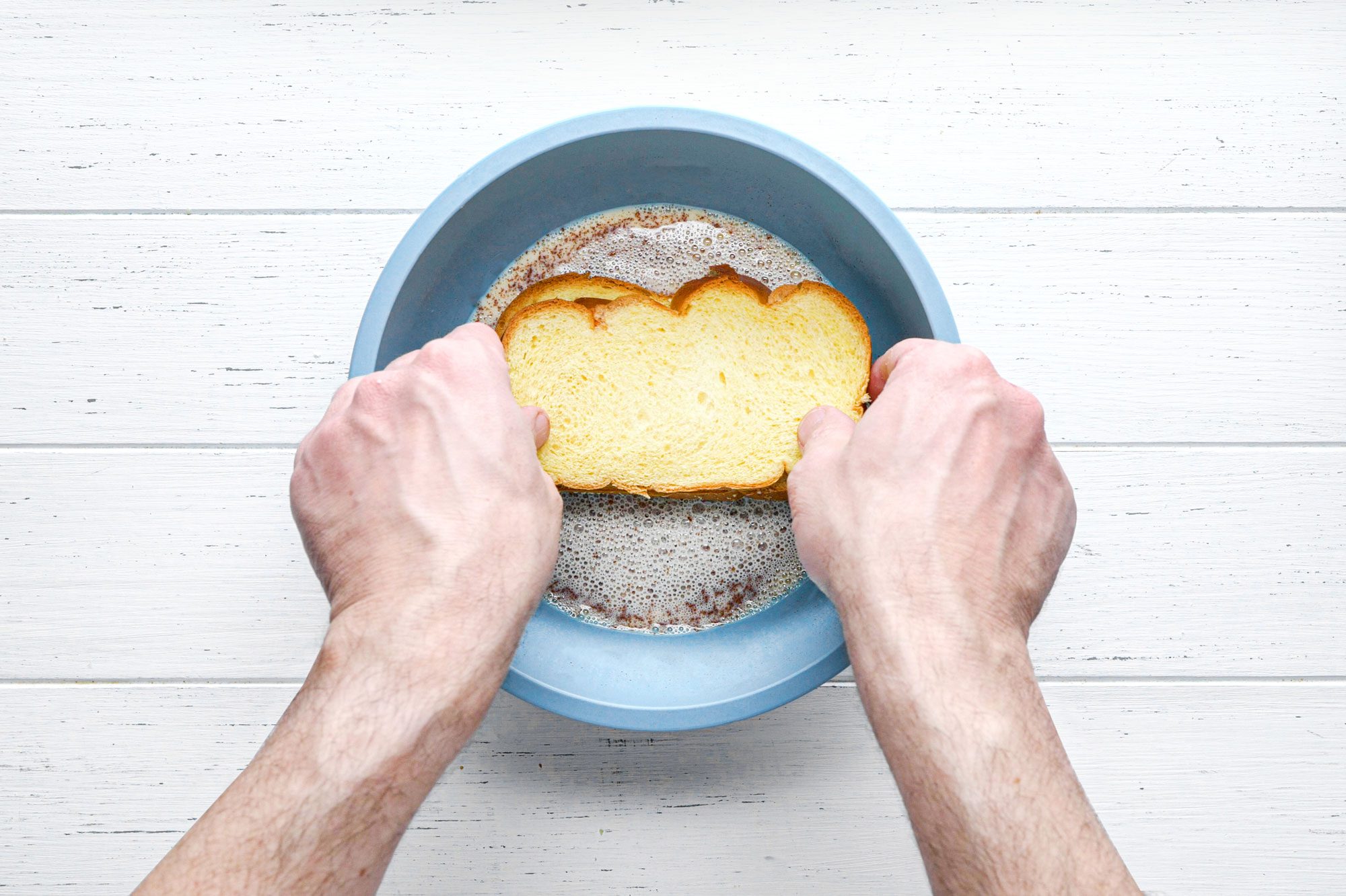 overhead shot of bread slice dipped in the egg mixture