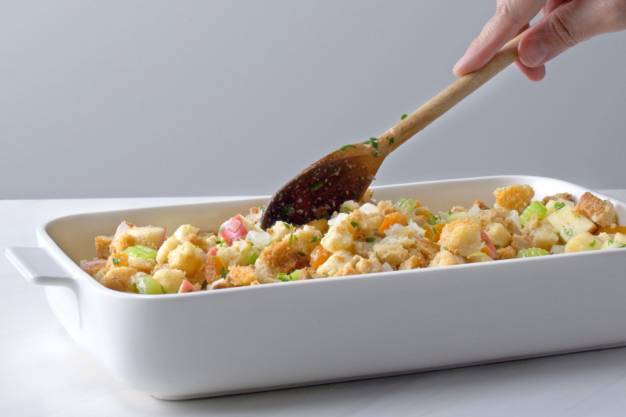 horizontal shot; grey background; stuffing Transferred to a greased baking dish;