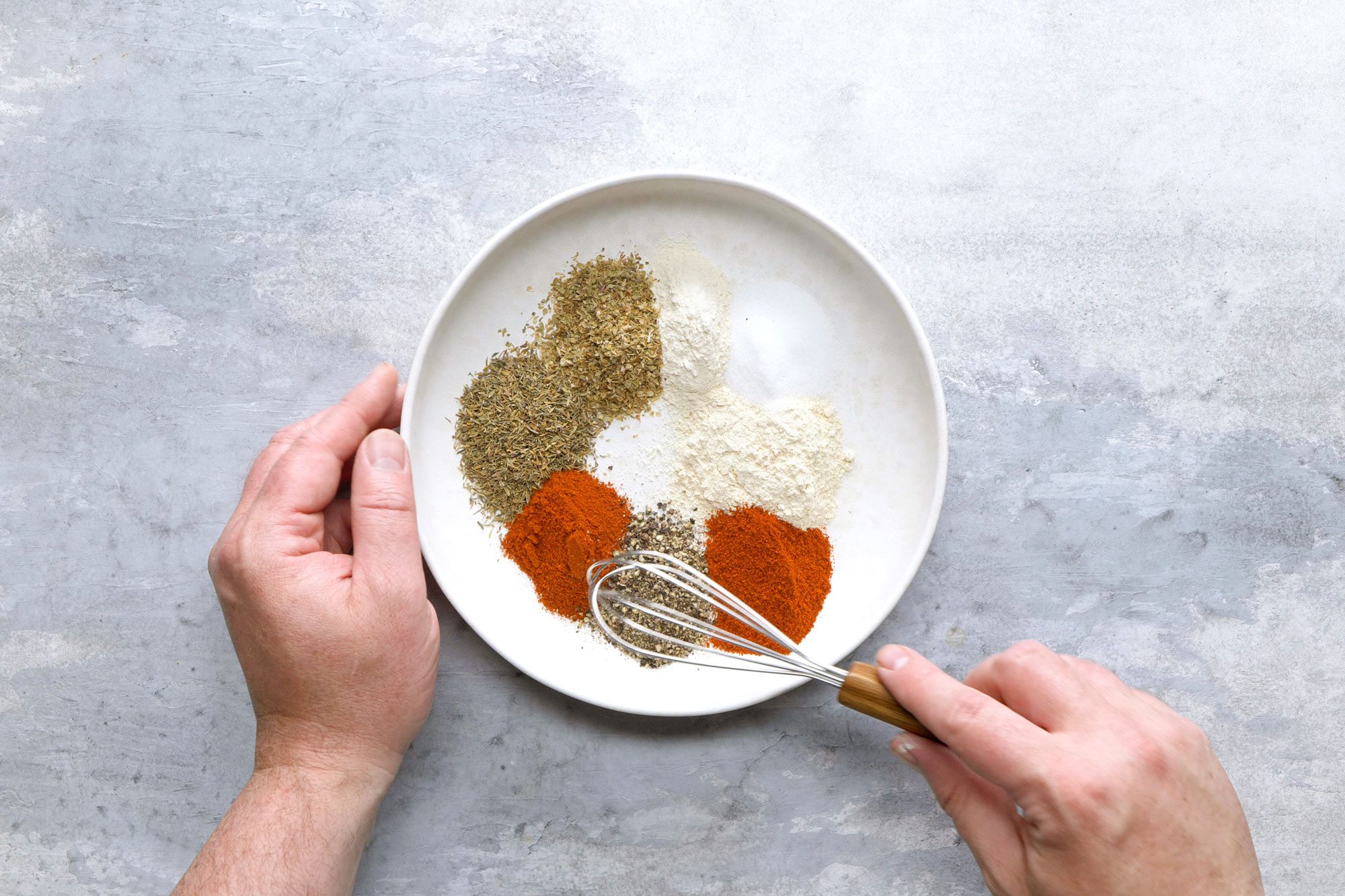 In a large, shallow dish, combine the herbs and spices and mix to combine