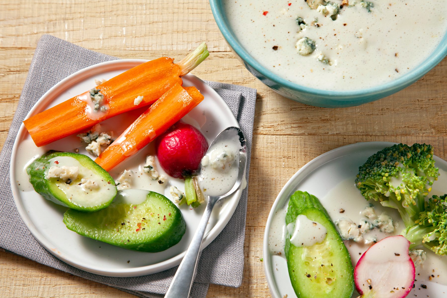 A serving of carrot, cucumber slices topped with Blue Cheese Vinaigrette