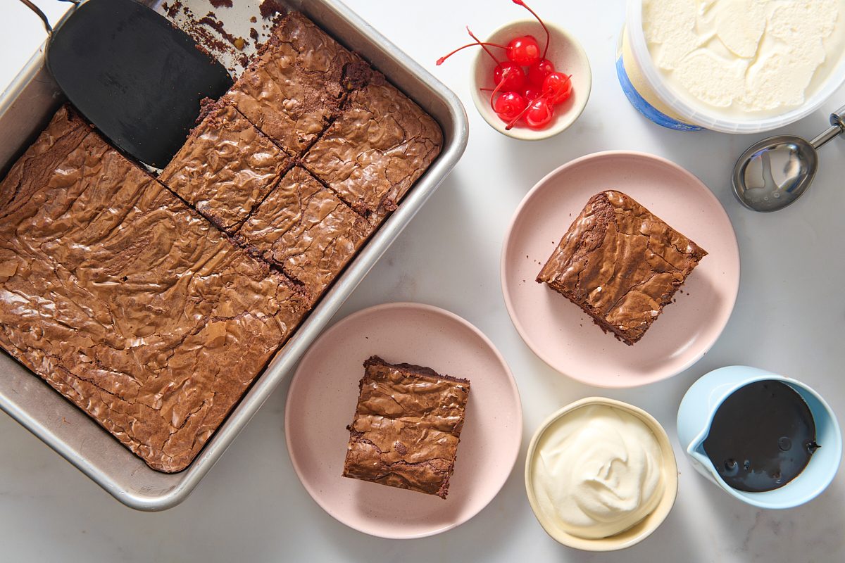 Cutting and assembling the brownie sundaes on plates