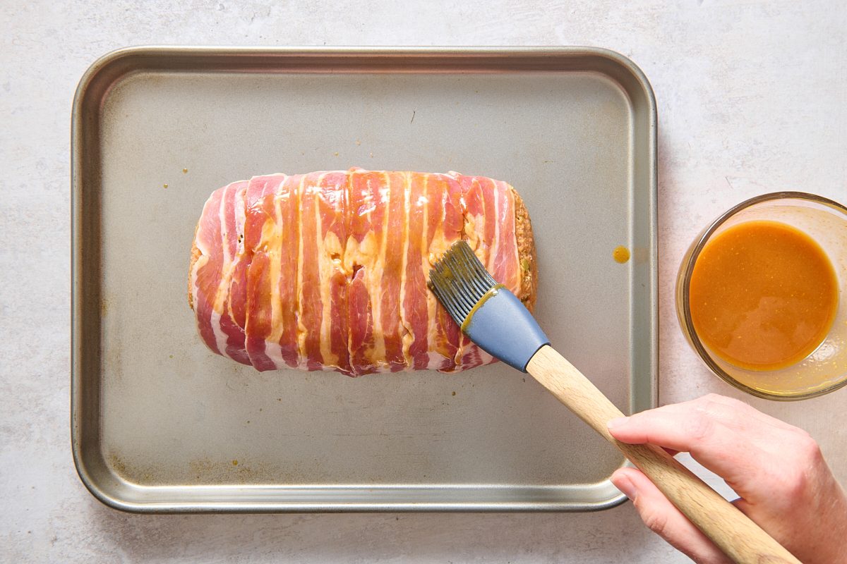 Brushing glaze over the meatloaf