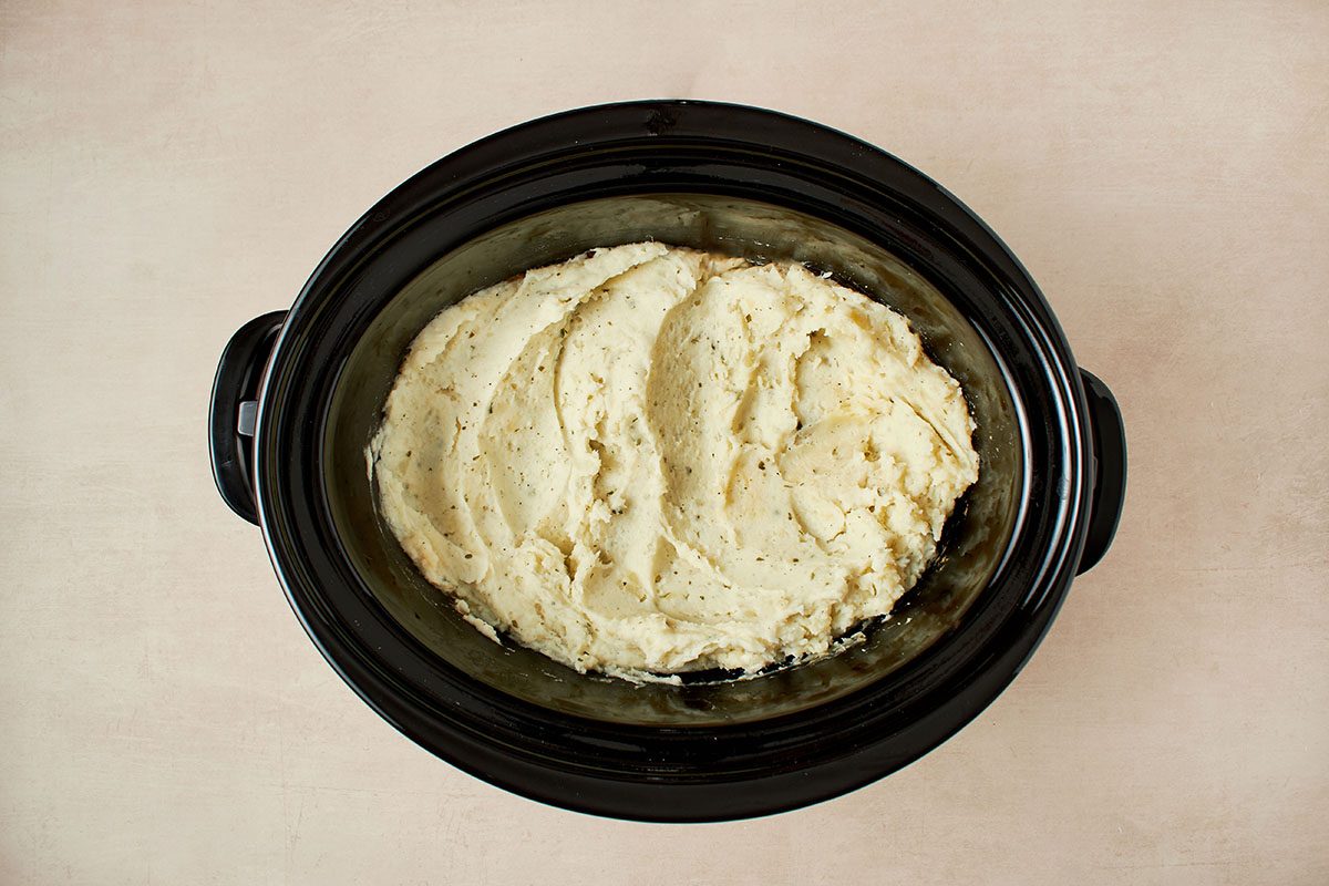 Cook mashed potatoes in crockpot.