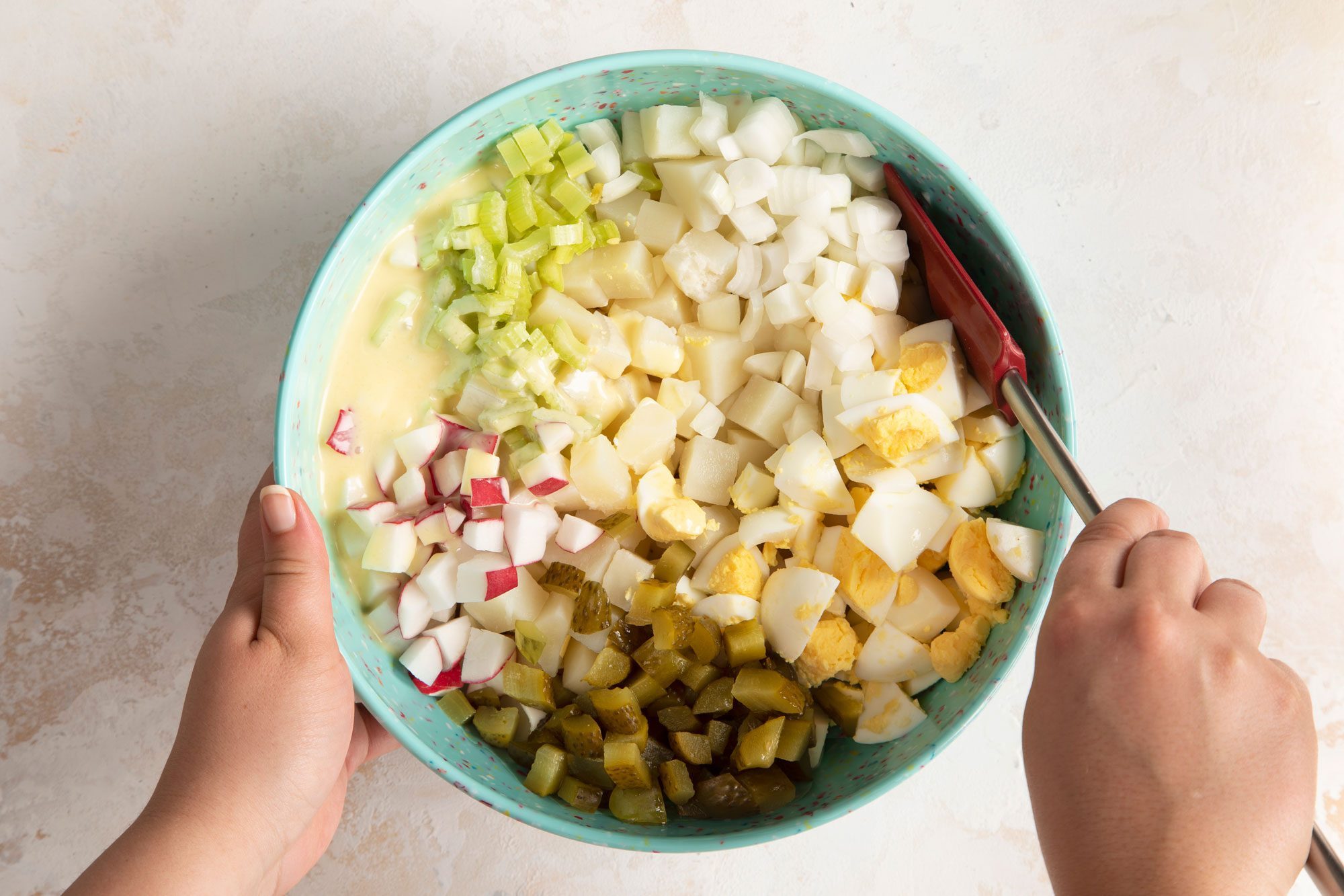 Stir carefully to coat the ingredients without smashing the potatoes and eggs