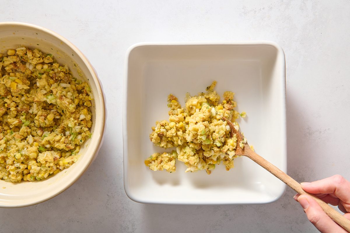 Spooning cornbread mixture into a baking dish