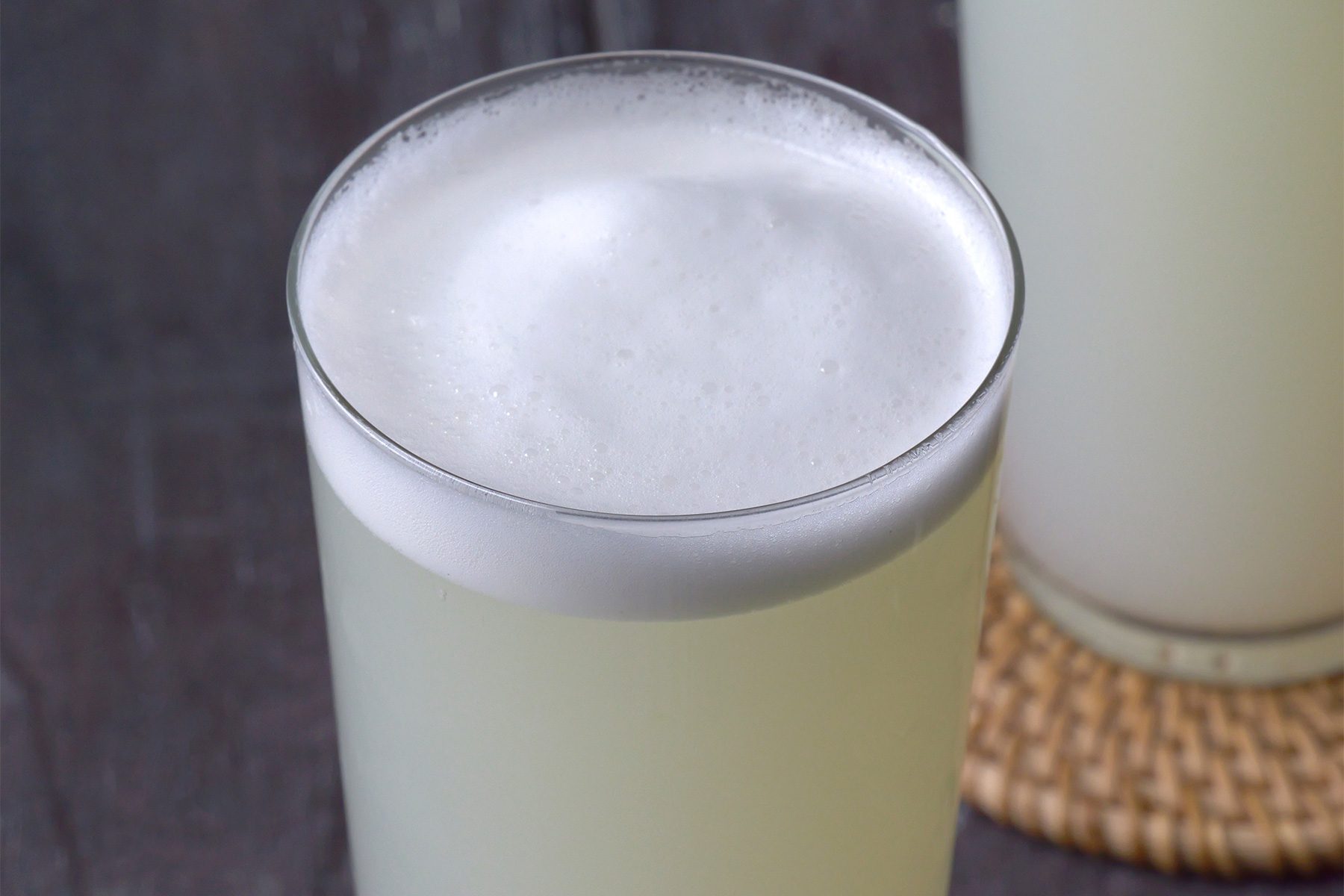close shot; Gin Fizz served in highball glasses placed over coasters