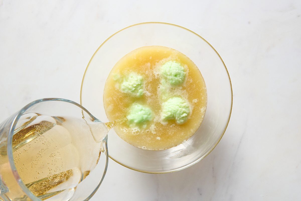 Combining the lime sherbet punch ingredients in a large bowl