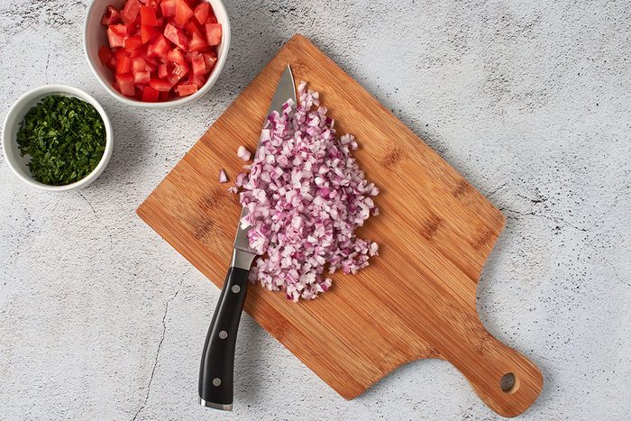 Chop tomato, onion, and cilantro.