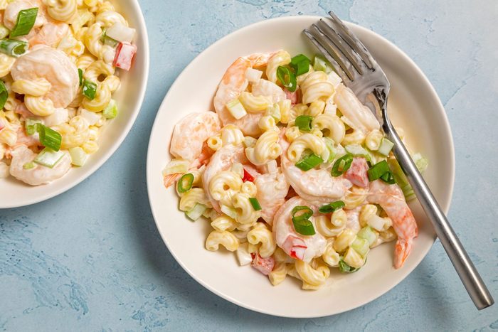 Two plates of Tasty Shrimp Pasta Salad served on small plates with cutlery