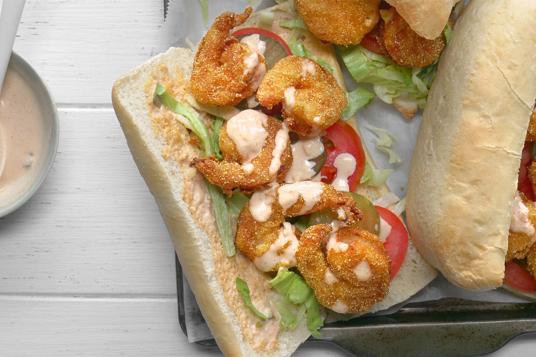 close shot; white background; Shrimp Po'Boys served on rectangular tray