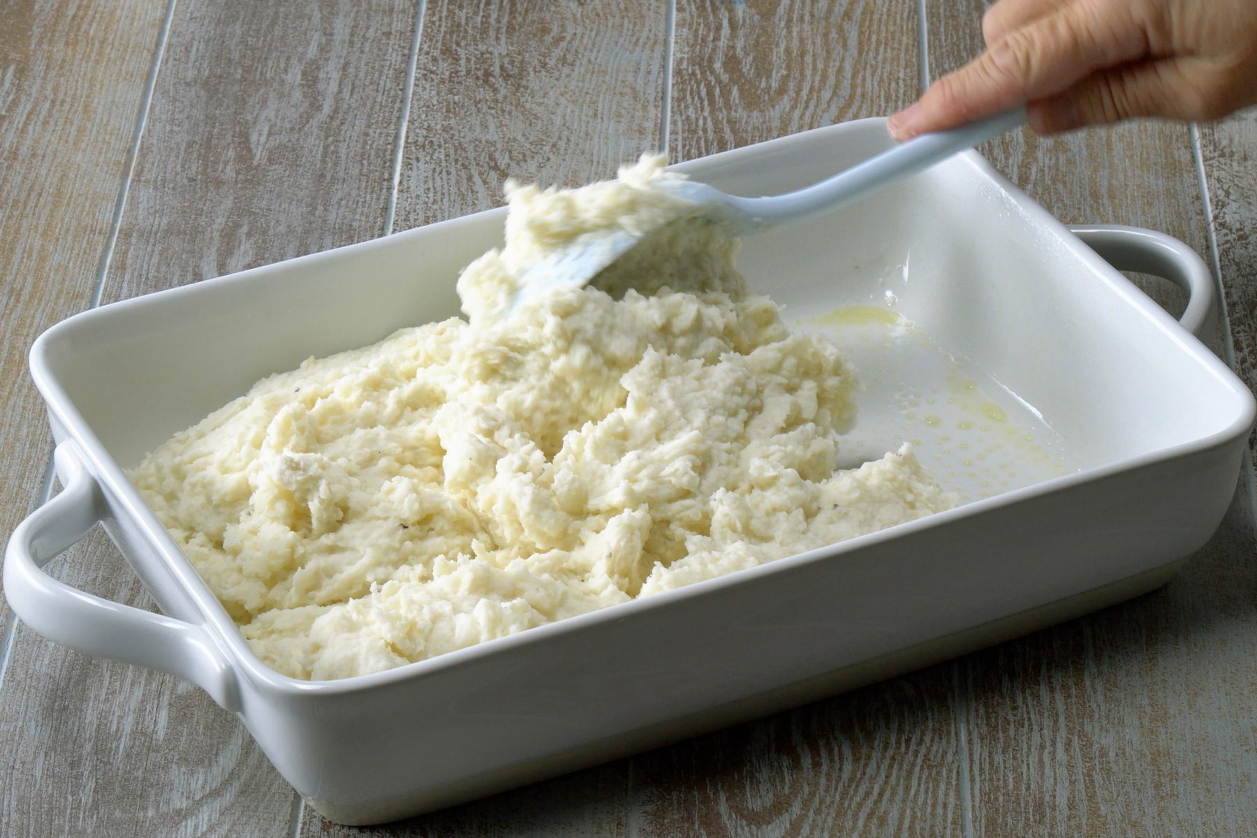 Spread the mashed potato mix in a greased baking pan