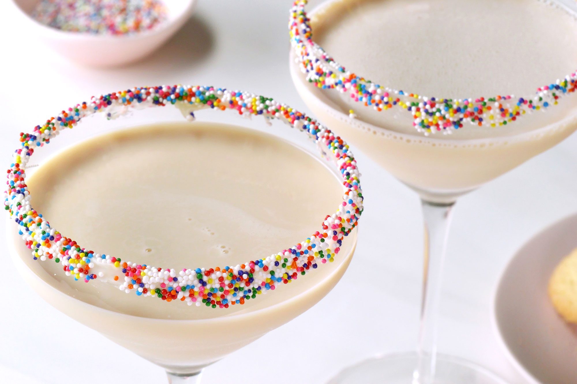Two Sugar Cookie Martinis topped with Christmas sprinkles