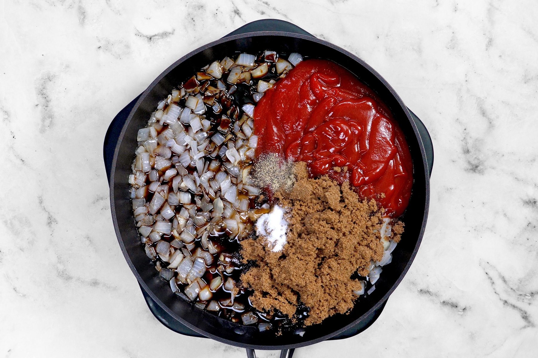 Add the ketchup, brown sugar, molasses, maple syrup, Worcestershire sauce, salt and pepper to the sauted onions and garlic