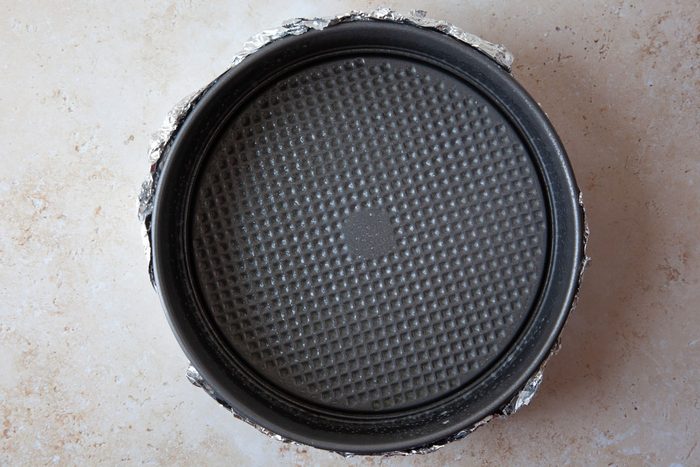 Step 1 of Taste of Home Caramel Apple Cheesecake is o wrap the pan with a double thickness of foil to create a water barrier