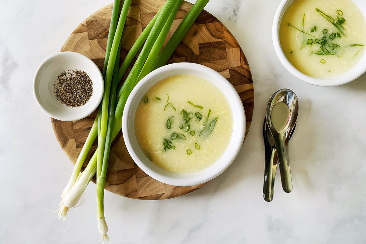 Overhead shot of Taste of Home's Egg Drop Soup recipe in a serving bowl on a white marble background
