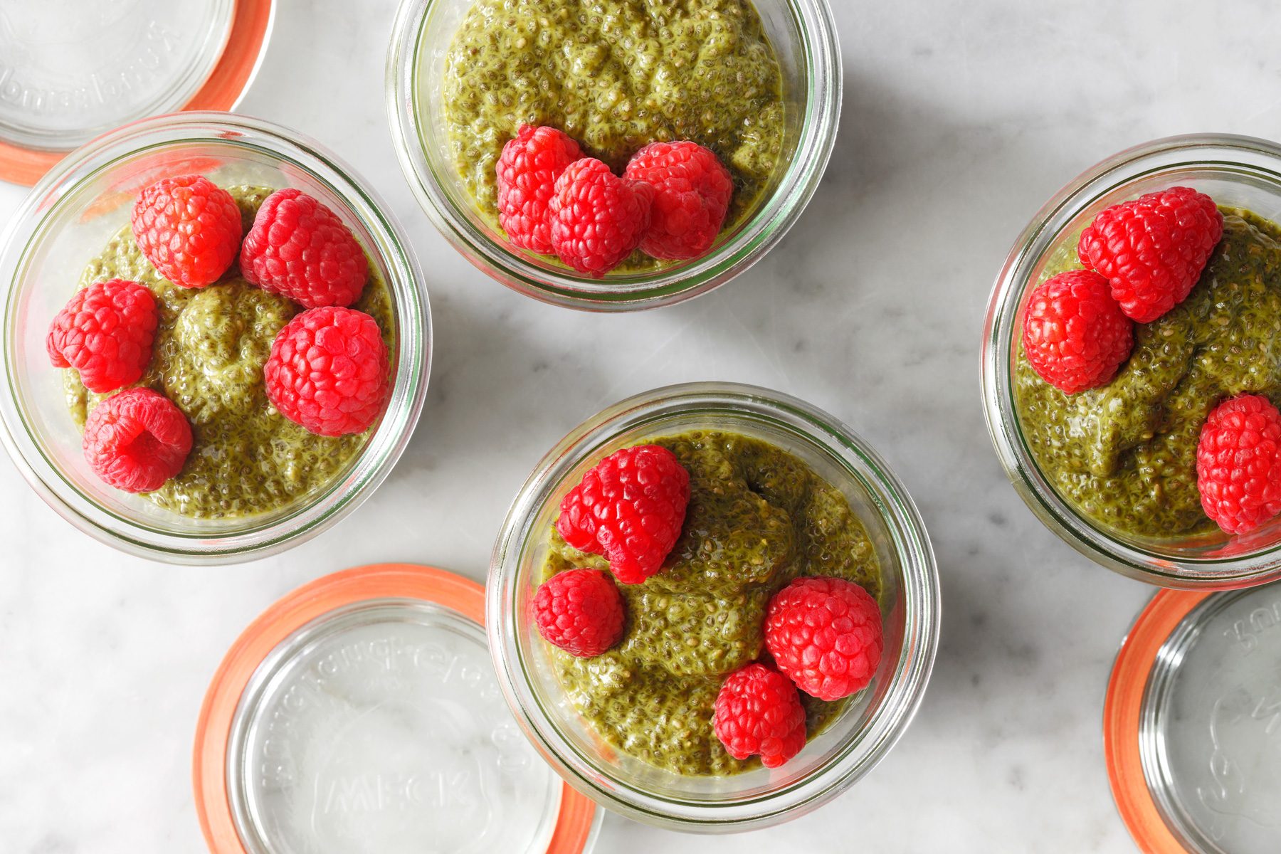 Overhead shot of Matcha Chia Puddings with there lids open