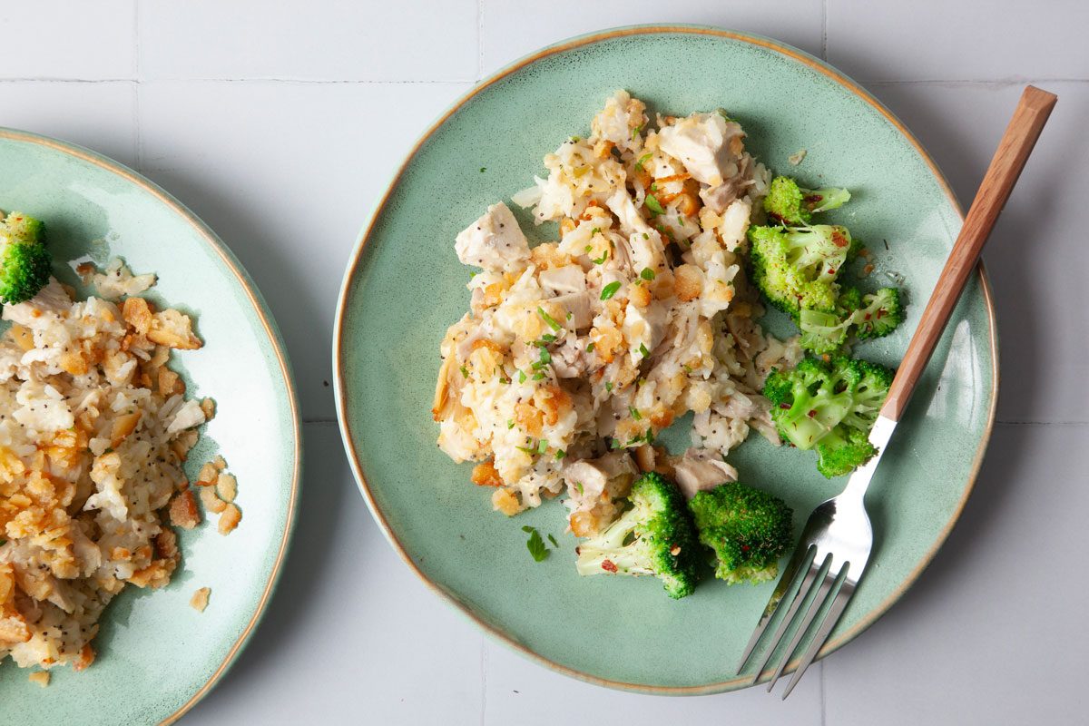 single serving of Taste of Home Poppy Seed Chicken on a green plate with broccoli